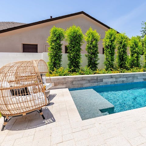 Curl up with a book in these rattan cocoons once you finish in the pool