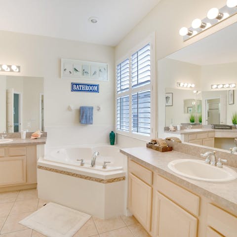 Run yourself a bubble bath in this dreamy corner tub, perfect for winding down at night