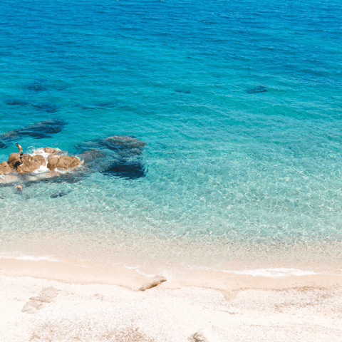 Immerse yourself in the blue waters of the Agios Ioannis beach, nine minutes  by car 