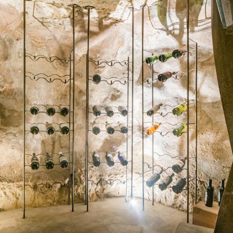 Select a bottle of high-end Sicilian wine from the cistern turned wine cellar