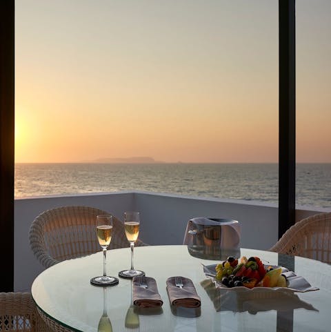 Enjoy a romantic drink on the balcony at sunset
