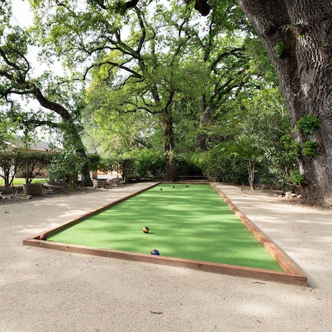 Play a game of bocce ball on the court in the garden