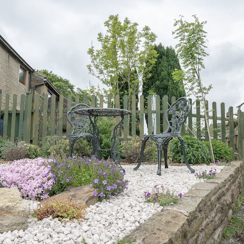 Sit out on the little bistro table in the cottage garden