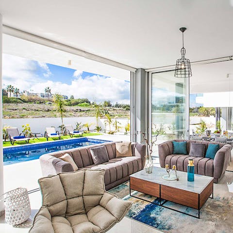 Kick back and relax in the light-filled living room courtesy of floor-to-ceiling sliding glass doors