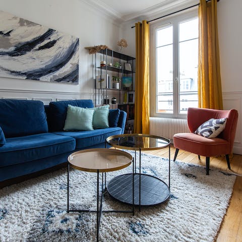 Kick back in the bright living room with a glass of French wine after a busy day of touring the city