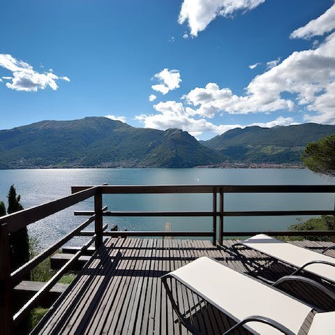 Gaze over the glassy lake surface to verdant hills from sunny terraces