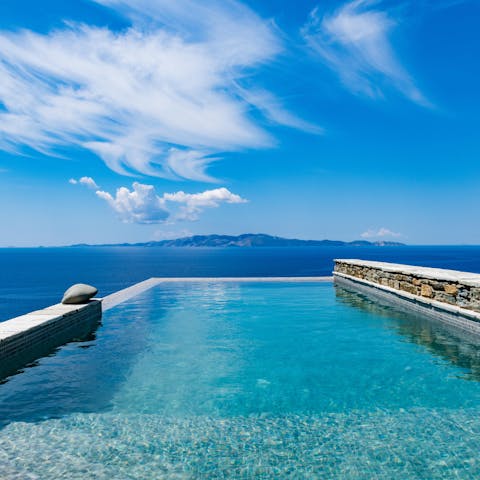 Float in the crystalline pool with a view of islands on the horizon