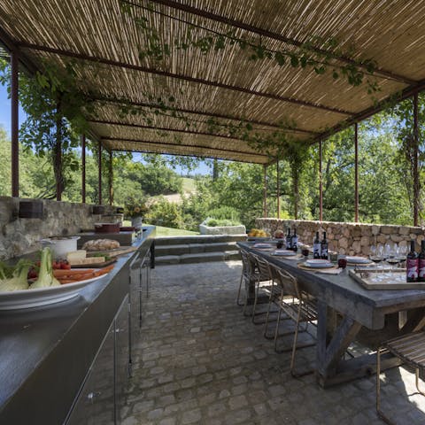 Cook in the outdoor kitchen and dine with a view of the Chianti hills
