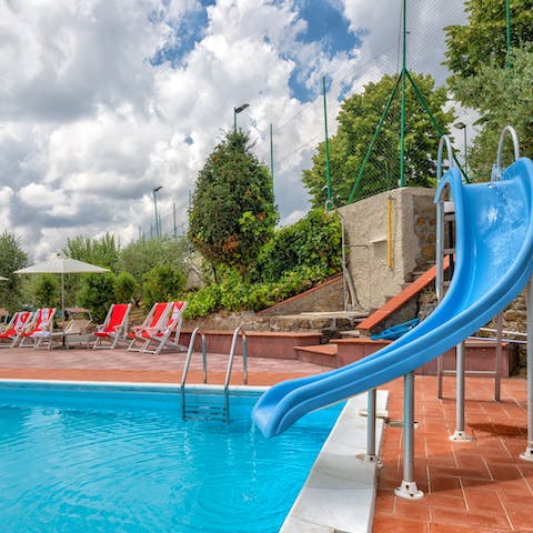 Speed down the slide into the invitingly blue waters of the swimming pool