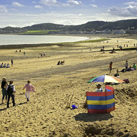 Chill out on Conwy Morfa Beach, a five-minute drive or thirty-minute walk away