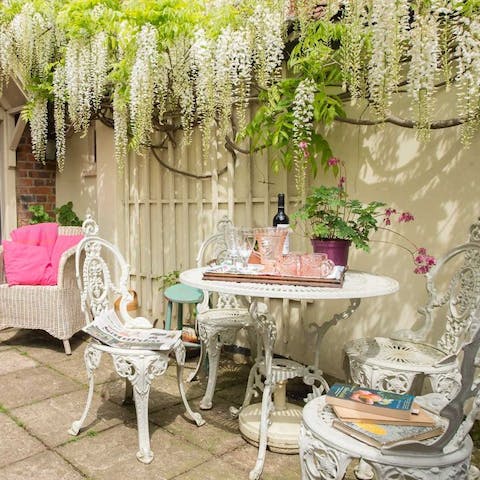 Enjoy a glass of Suffolk wine in the wisteria clad courtyard