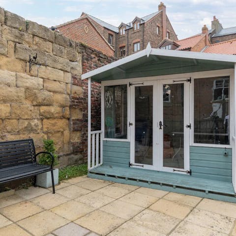 The patio with summer house makes an outdoor play area for kids, even when it's raining