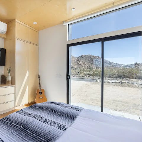 Wake up to the sun rising up over the mountains and admire the view from bed