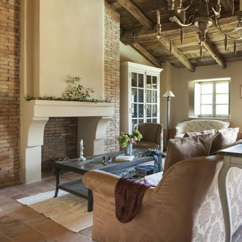 Kick back and relax in the elegant living room beneath beautifully vaulted, wooden ceilings