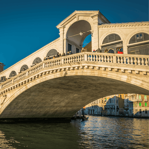 Visit the Rialto Bridge, a fifteen-minute walk away