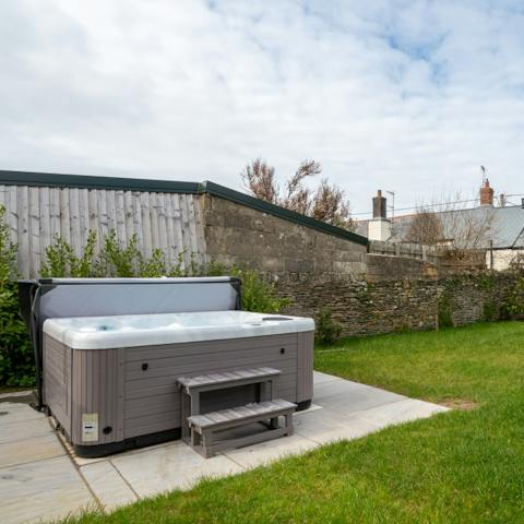 Soak in the outdoor hot tub and watch the stars descend