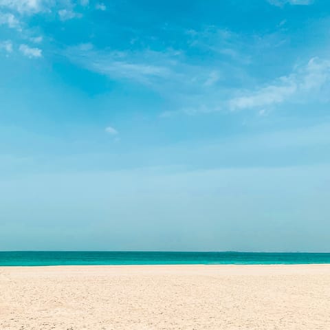 Relax on the sandy beach just a seven-minute walk away