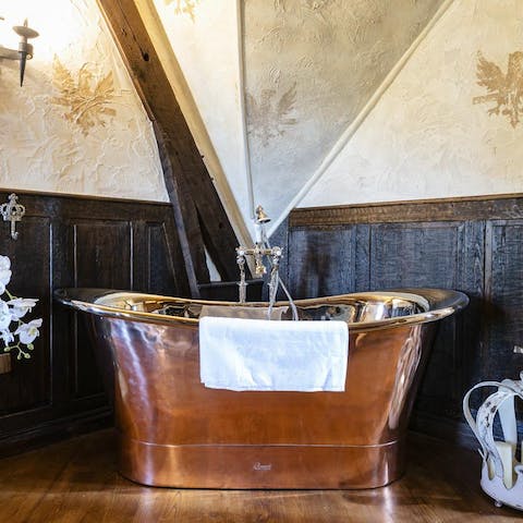This grand copper bathtub in the master bathroom suite
