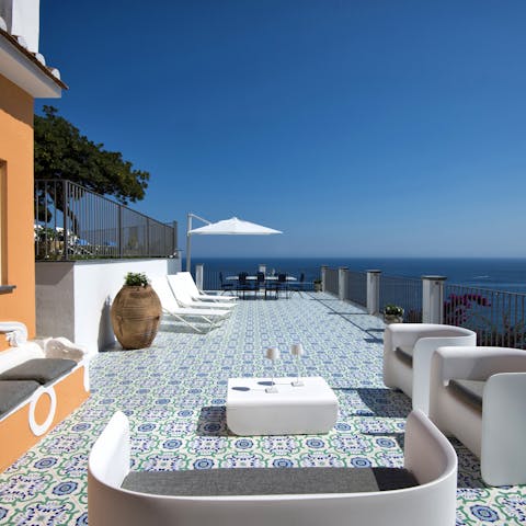 Step out onto one of the private terraces to enjoy drinks against the gorgeous backdrop of the sea