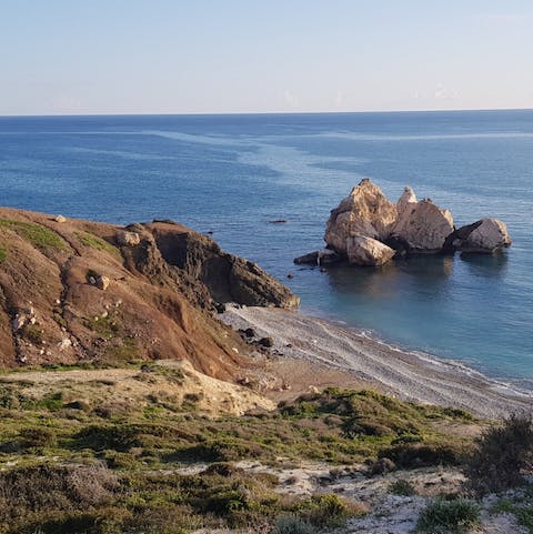 Visit Aphrodite's Rock off the coast of Paphos and the scenic pebble beaches closeby