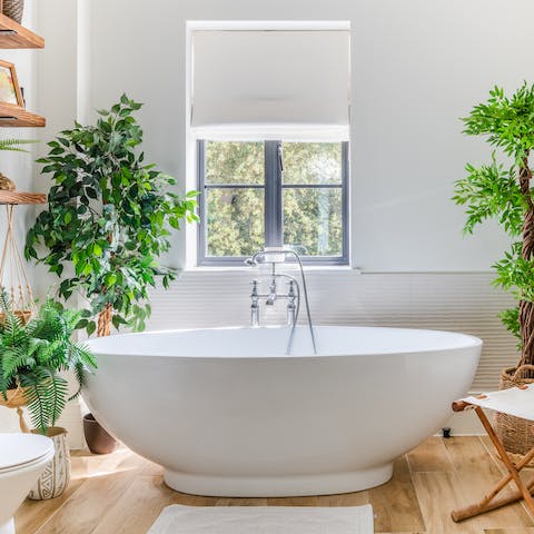Soak amidst the greenery in the free-standing tub