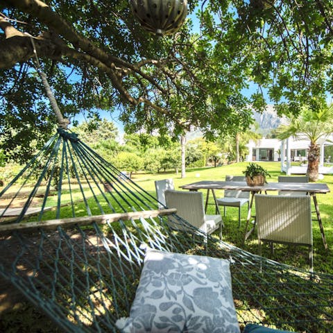 Kick back on the hammock, shaded by a flourishing tree