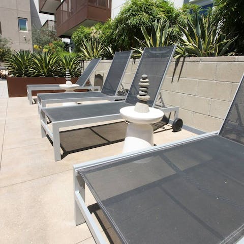 Sunbathe on the day beds of the residence's shared rooftop terrace 