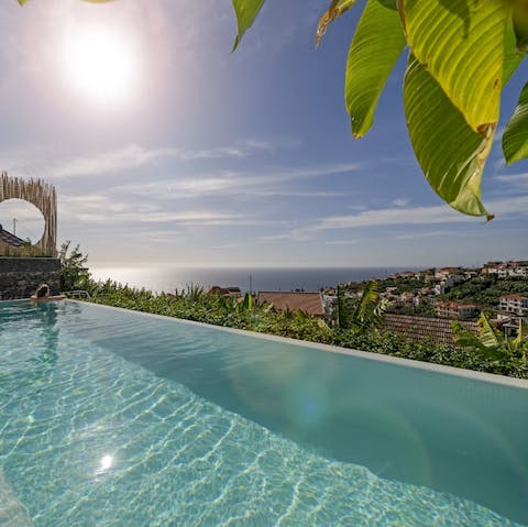 Plunge into the shared infinity pool overlooking the town
