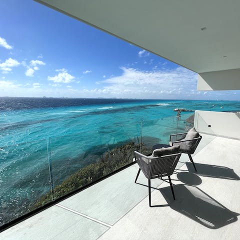 Sit out on the private balcony with a drink as the sun sets over the sea