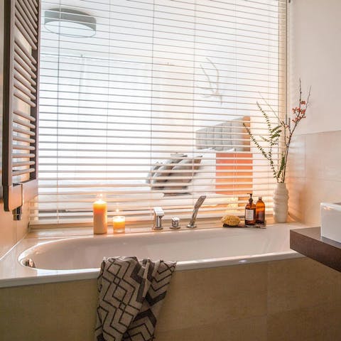 Light some candles, pour yourself a glass of wine, and soak in the tub after a long day of exploring