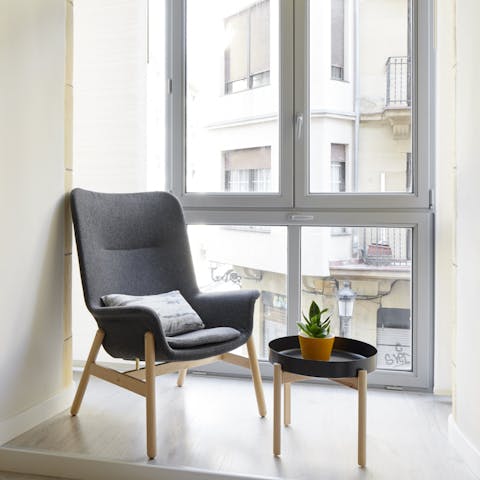 Grab a book and settle into the chair by the floor-to-ceiling windows