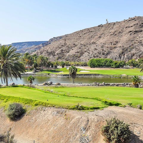 Play a round of golf on this resort's golf course with its mountain backdrop