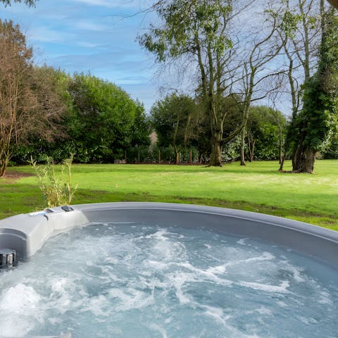 Enjoy peaceful garden views while relaxing in the hot tub