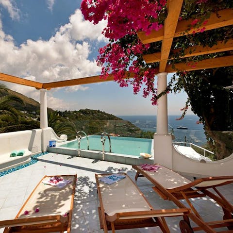 Soak in the stunning views of the hills and the sea from the raised pool deck