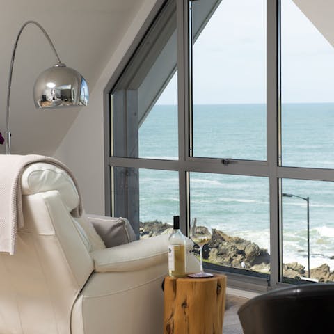 Take in the coastal scene from the sofa area, perhaps with a glass of wine in hand