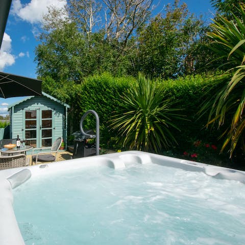 Sip on a nice glass of wine as you relax in the bubbling hot tub
