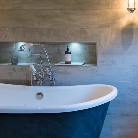 Treat yourself to a rejuvenating soak in the home's elegant free-standing bathtub