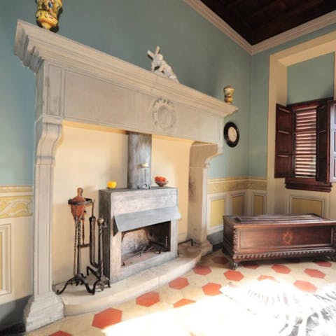 Admire original features like the grand fireplace in the dining room