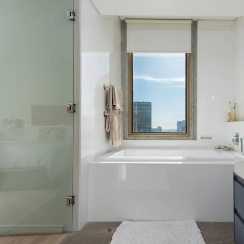 Indulge in a soak session overlooking the illuminated cityscape