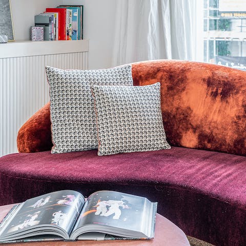 Relax on the comfy, curvy velvet sofa after a busy day of sightseeing