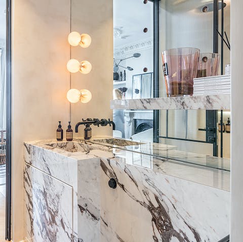 Get ready for an evening out in London in the stylish marble-clad bathroom