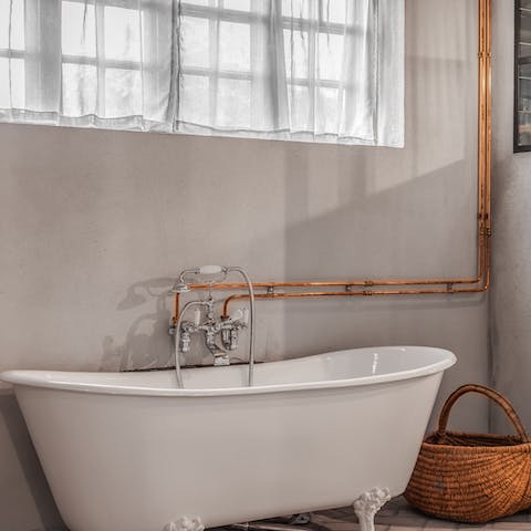 Close your eyes and sink back into soothingly warm water in the clawfoot tub