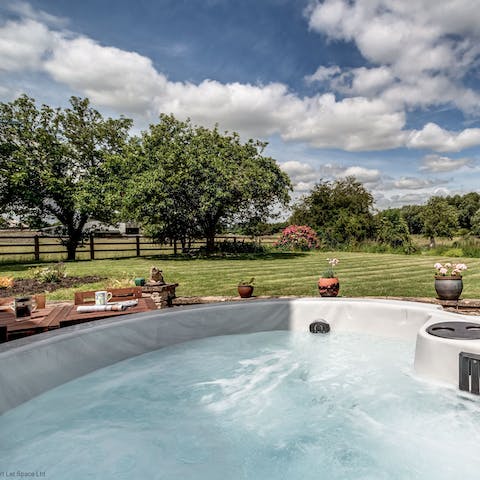 Watch horses and alpacas trot about the meadows from the hot tub