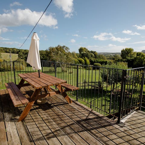Soak in the views of the surrounding green acres from your private balcony