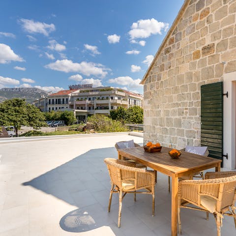 Dine alfresco on the roof terrace with mountain views providing the perfect backdrop