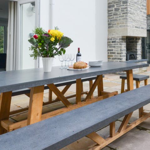 Dine alfresco next to the warmth of the outside fireplace