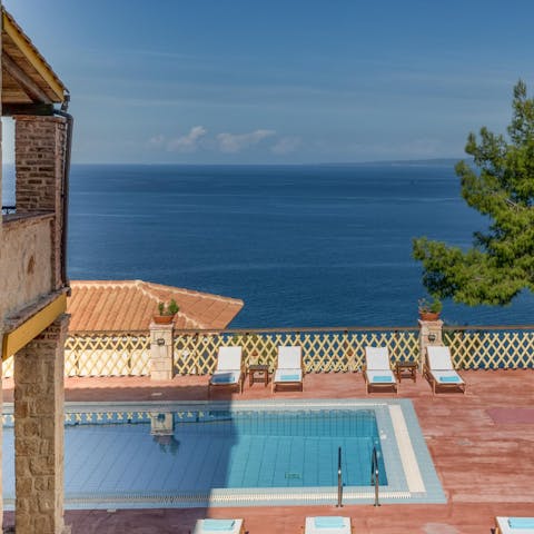 Swim laps in the pool overlooking the Aegean Sea