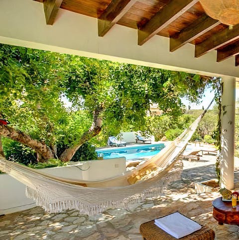 Lay back and relax with a good book in the hammock, located under the shady terrace