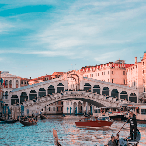 Watch the gondolas float by on the iconic Rialto bridge