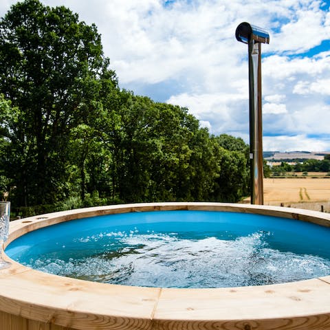 Soak the day away in the wood-fired hot tub overlooking the fields